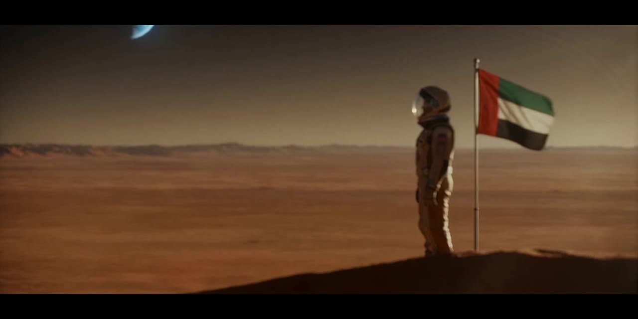 The pioneer beside the UAE flag on Mars